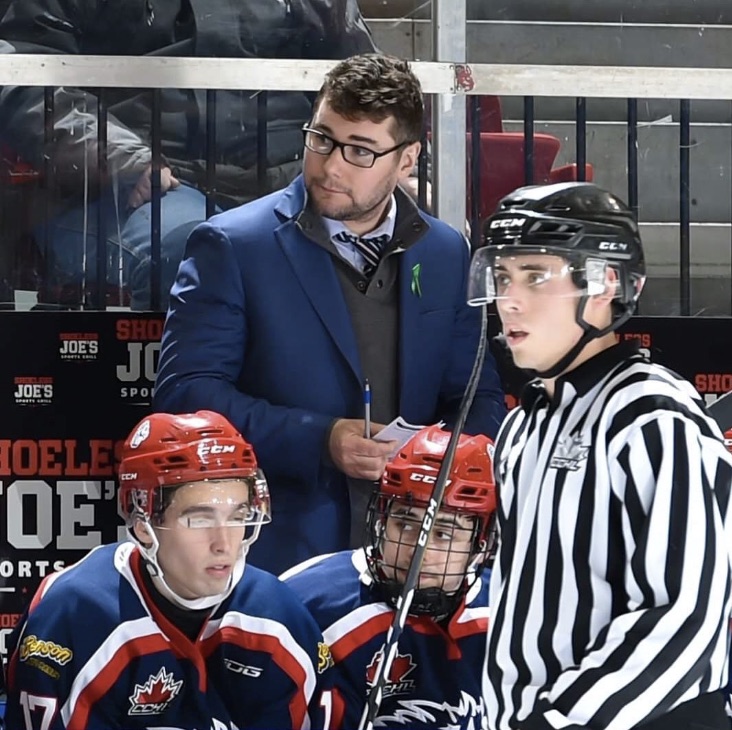 Keif Orsini behind the bench during a game