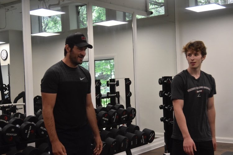Scott Berish coaching an athlete through a session in the gym