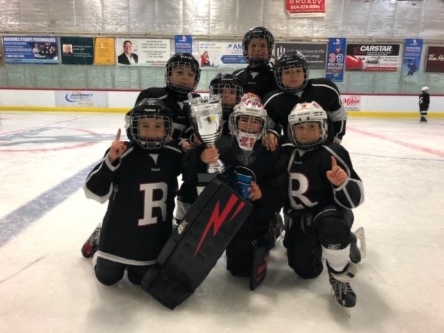 Rapid Hockey Spring AAA team posing with a tournament trophy