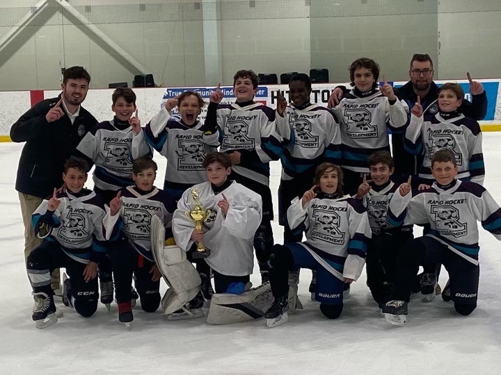 Rapid Hockey team celebrating a championship on the ice